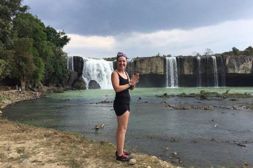 A person standing by a waterfall with multiple cascades. 4