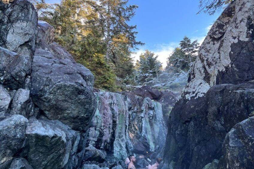 A rocky canyon with a waterfall. 5