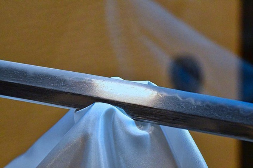 A metal railing with a white fabric draped over it. 4