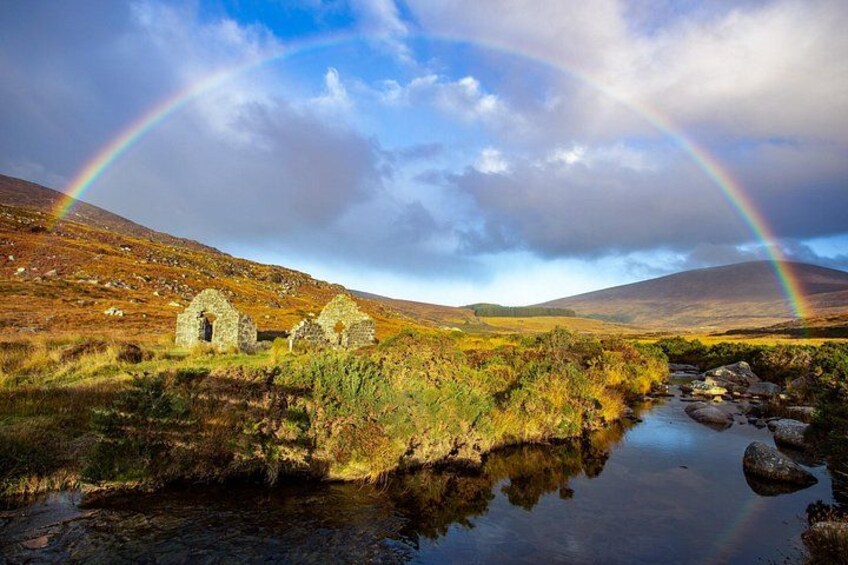 A landscape with a rainbow, a stream, and stone ruins. 2