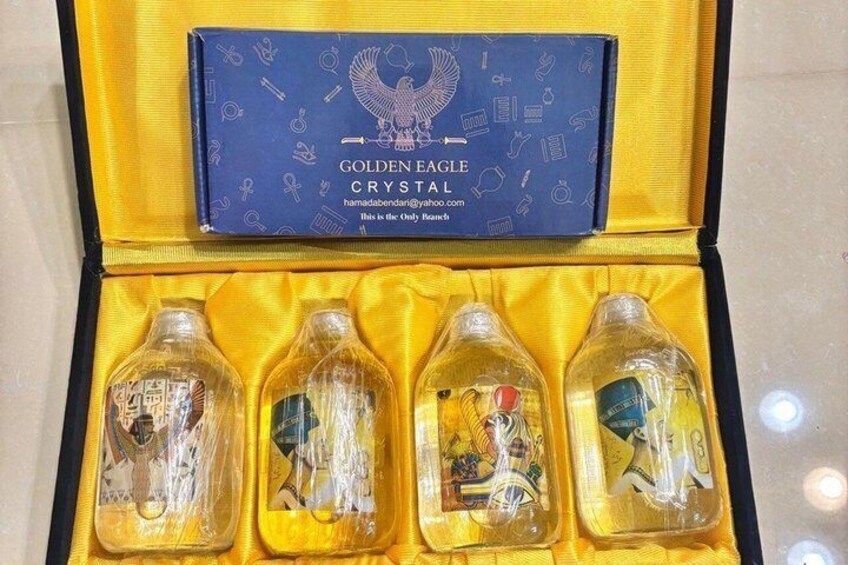 A blue box with the text 'GOLDEN EAGLE CRYSTAL' and four clear bottles with labels inside a yellow box. 3
