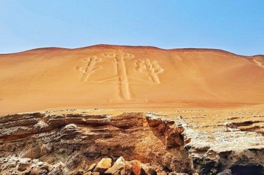 A desert landscape with a large sand dune and rock formations. 1