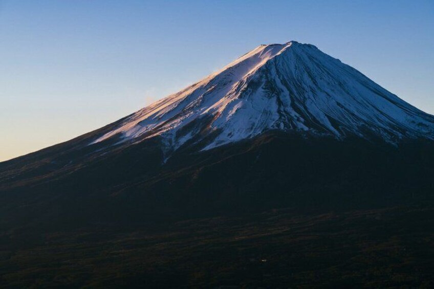 A snow-capped mountain with a clear sky. 2