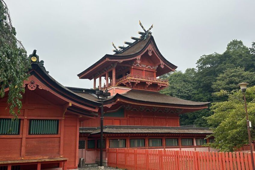 A traditional Japanese temple with a red roof and ornate architecture. 3