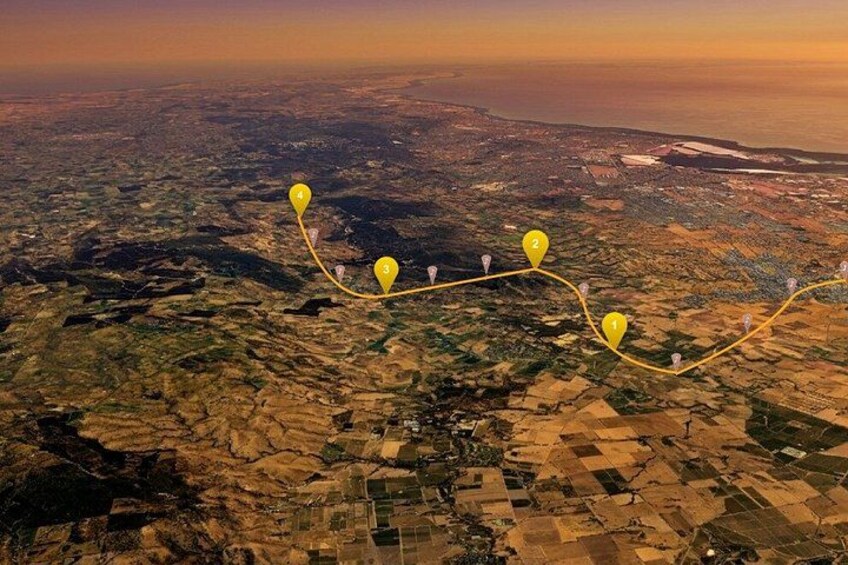 An aerial view of a landscape with numbered markers indicating a route. 5