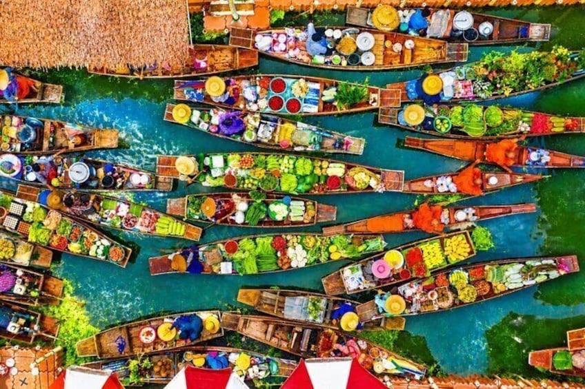 A vibrant floating market with numerous boats laden with fresh produce and goods. 1