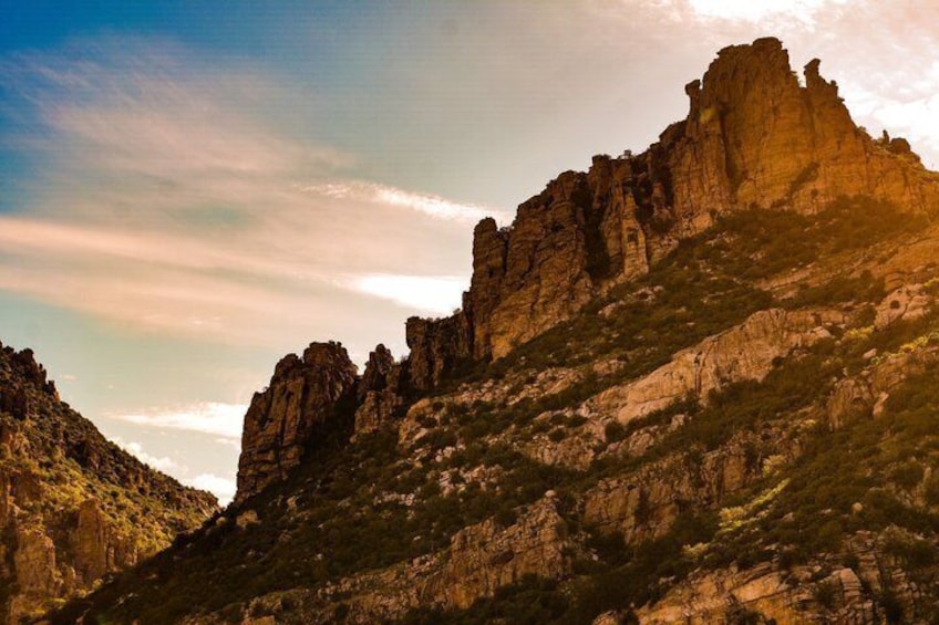 A rugged mountain landscape with prominent rock formations and sparse vegetation. 1