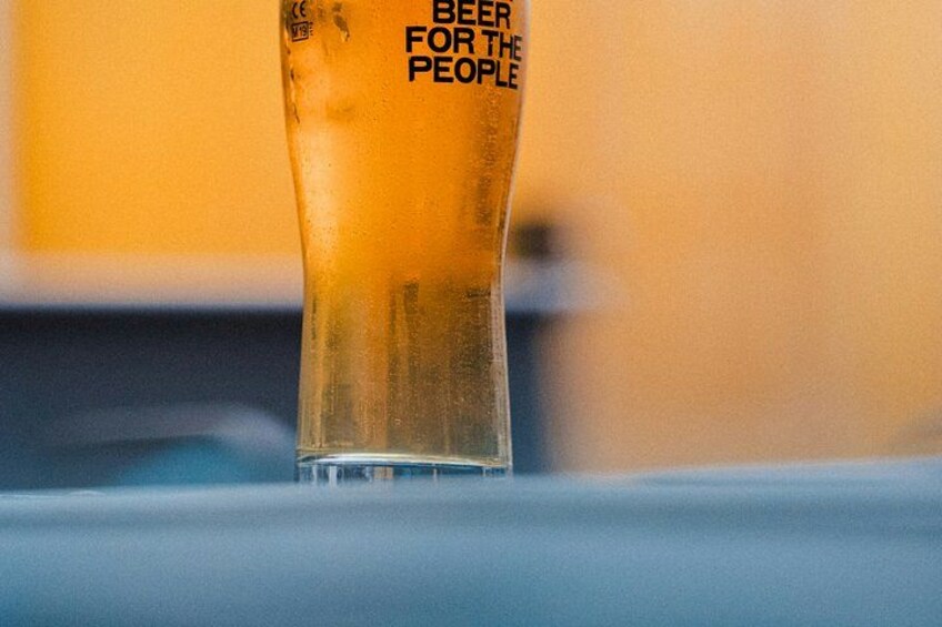 A glass with a label that reads 'BEER FOR THE PEOPLE'. 4