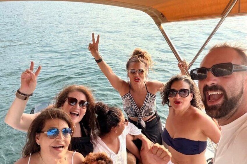 A group of people on a boat with water in the background. 1