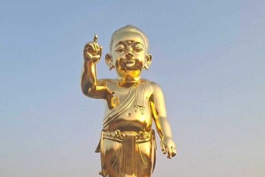 A golden statue with a raised hand, wearing a draped garment. 2