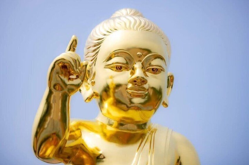 A golden statue with a raised hand. 4
