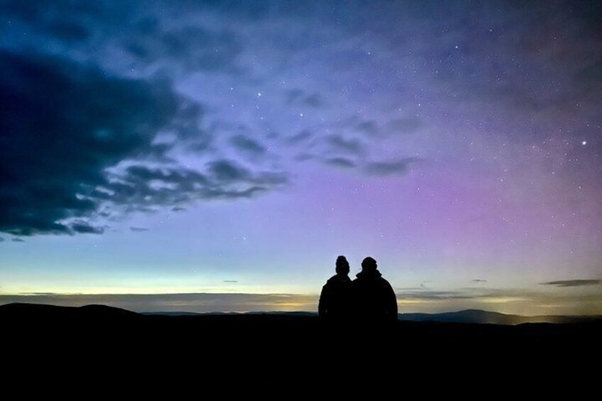 Two people silhouetted against a starry night sky. 1