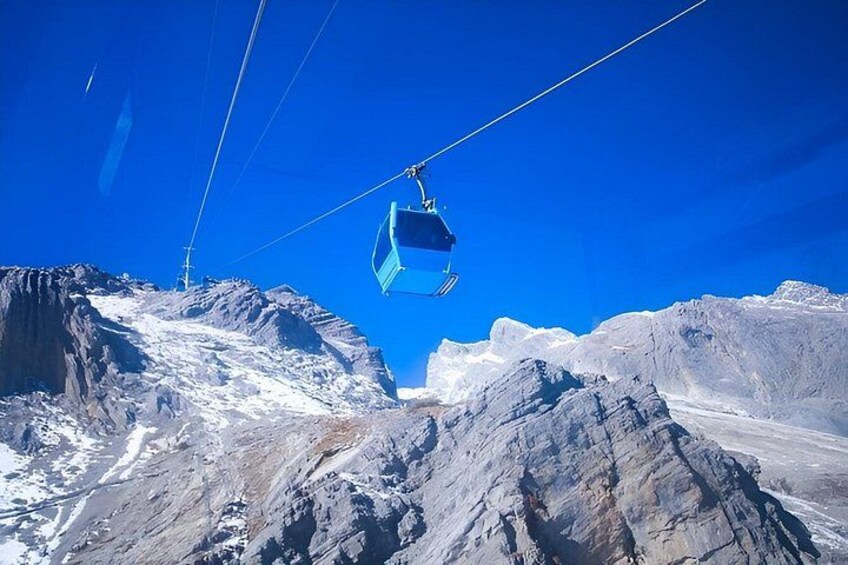 A cable car suspended over a mountainous landscape. 1