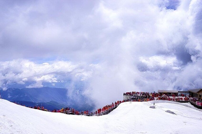 A snowy mountain landscape with a ski lift and a crowd of people. 5