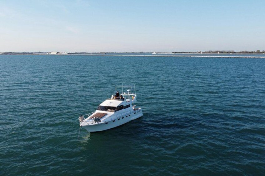 A white yacht on calm waters with a clear sky. 3