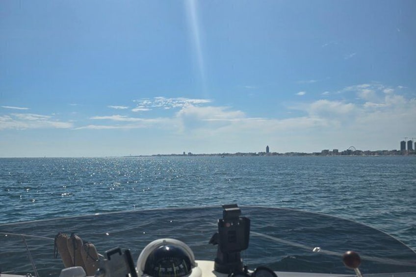 A boat on water with a city skyline in the distance. 5