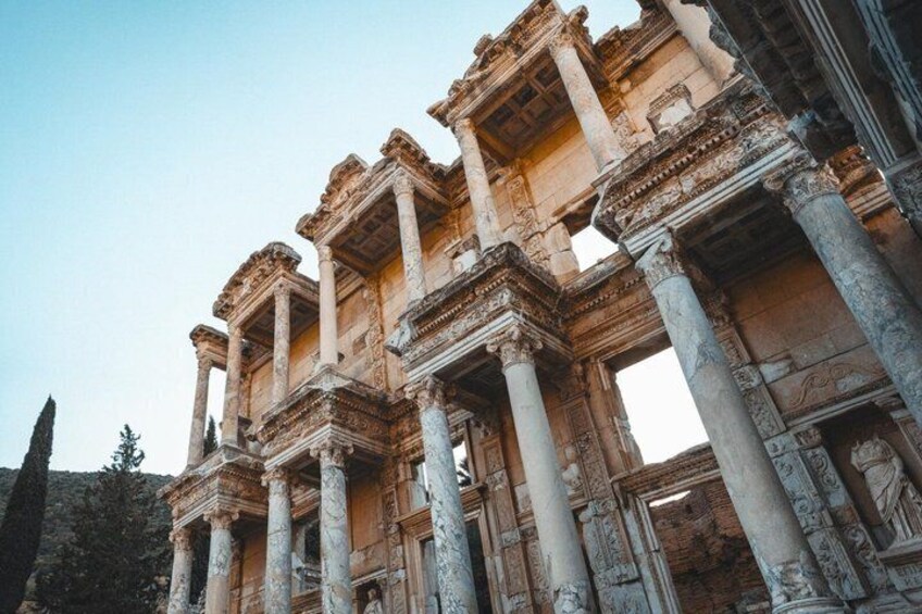 Ancient ruins with columns and intricate carvings. 1