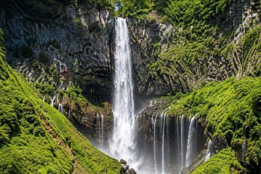 A multi-tiered waterfall surrounded by lush greenery. 5