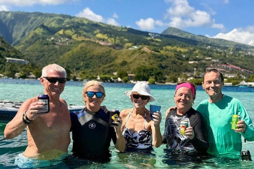 A group of people in a boat on a lake with mountains in the background. 4