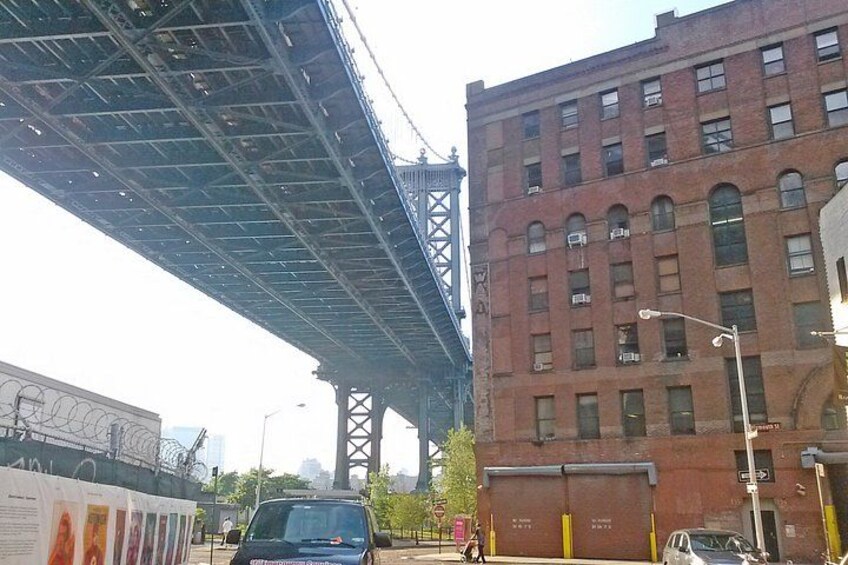 A bridge, a red brick building, and a street with cars. 2