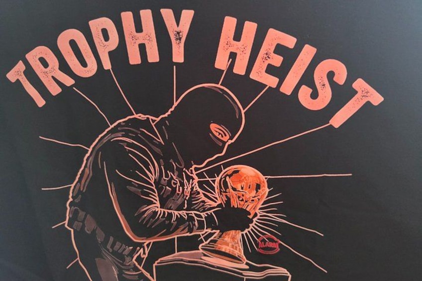 A person holding a trophy with the text 'TROPHY HEIST' above them. 2