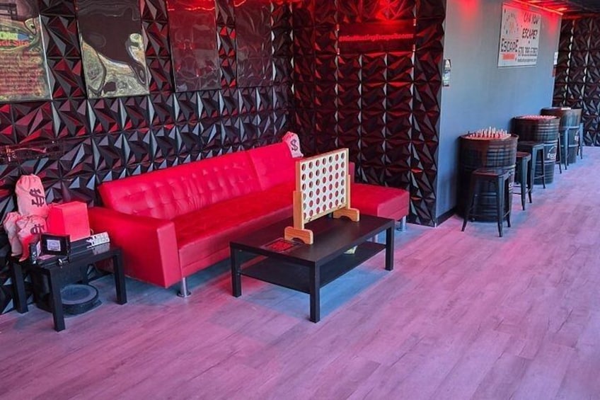 A red sofa, a black coffee table, and a patterned wall. 3