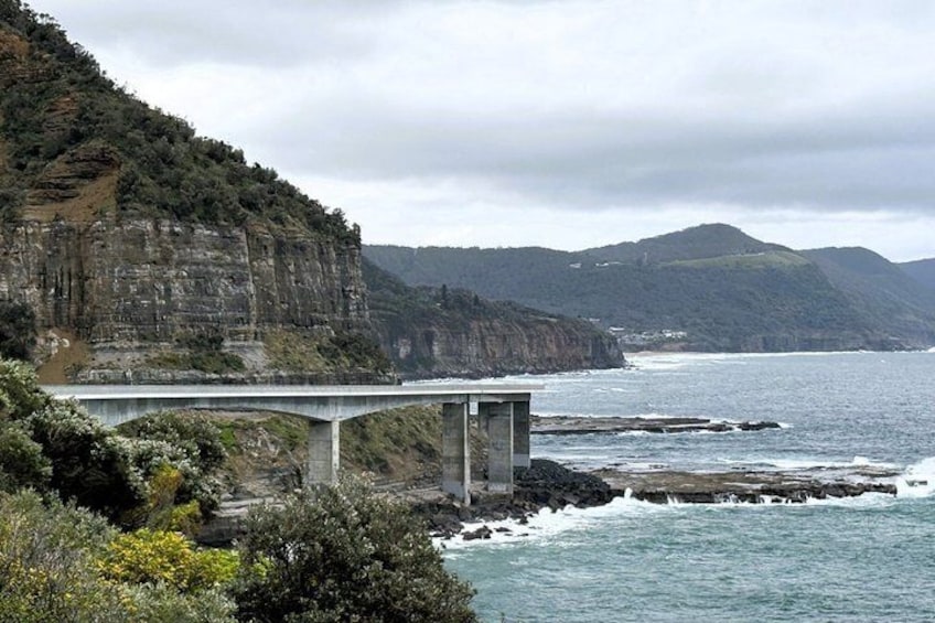 A coastal bridge, cliffs, and ocean. 4