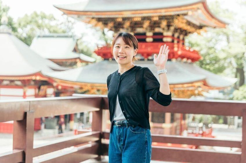 A person standing on a bridge with traditional Japanese architecture in the background. 3