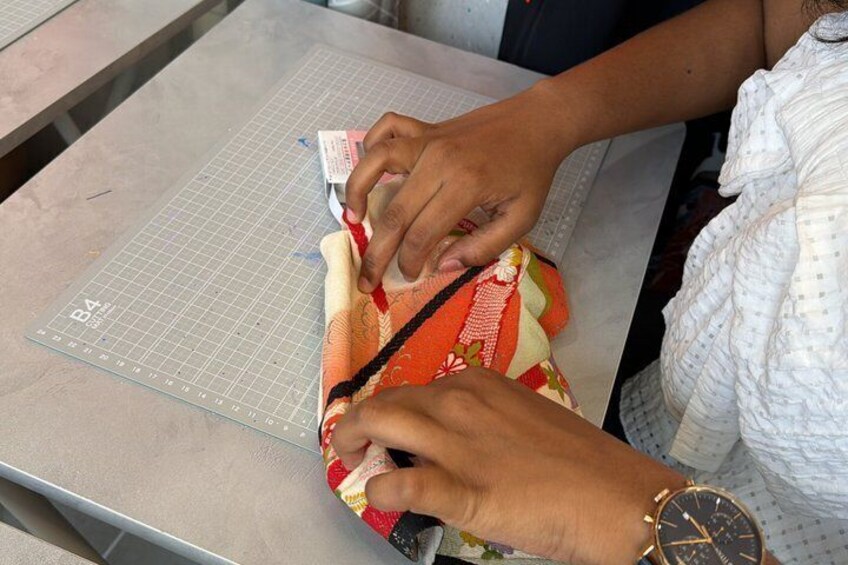 A person cutting fabric on a cutting mat. 5