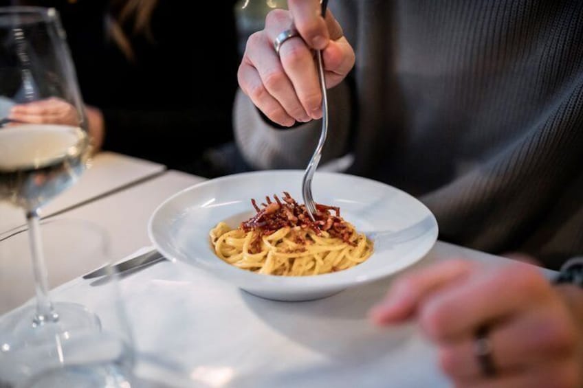 A person eating pasta with a fork. 2