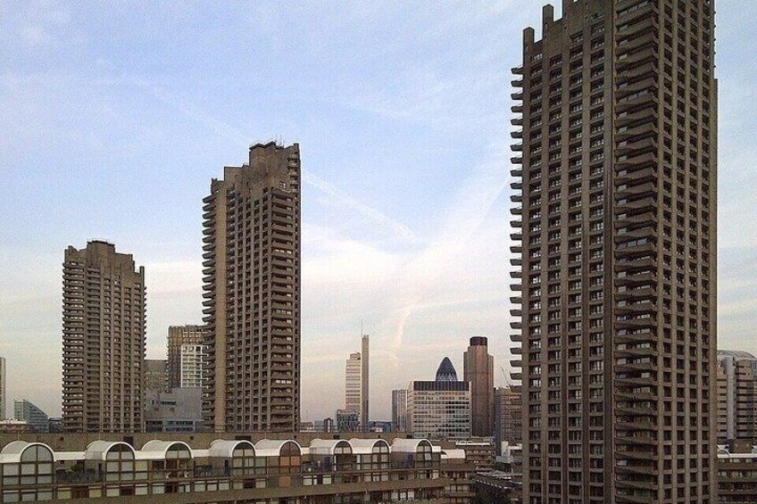 A cityscape with multiple high-rise buildings, a clear sky, and a bridge in the foreground. 4