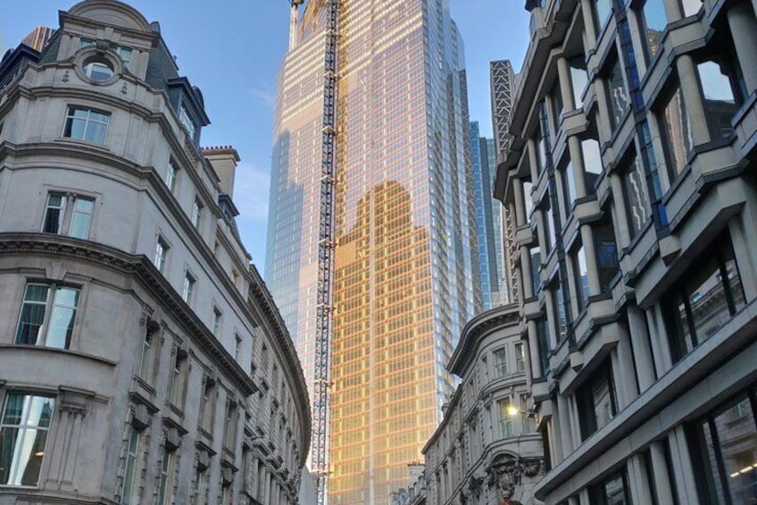 A historic building with ornate architecture, a modern skyscraper, and another historic building with classical design. 1