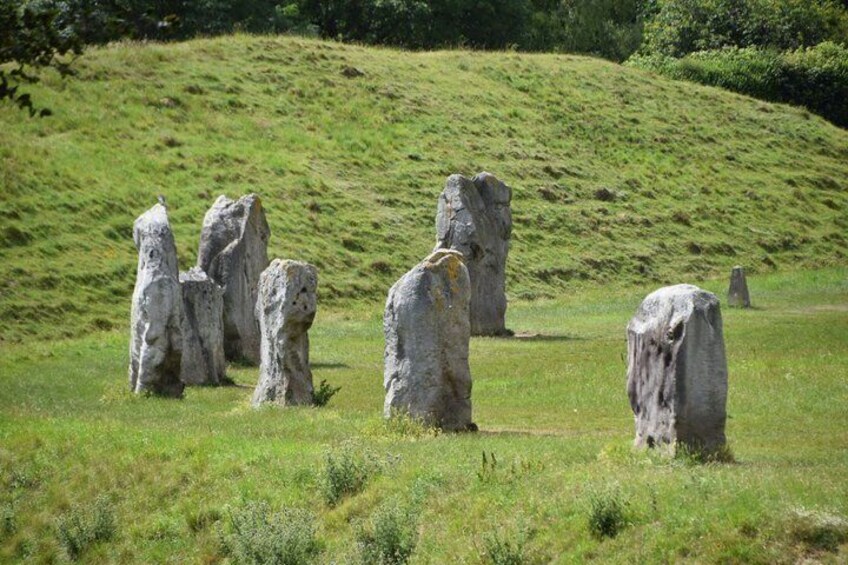 A grassy field with several large standing stones. 1
