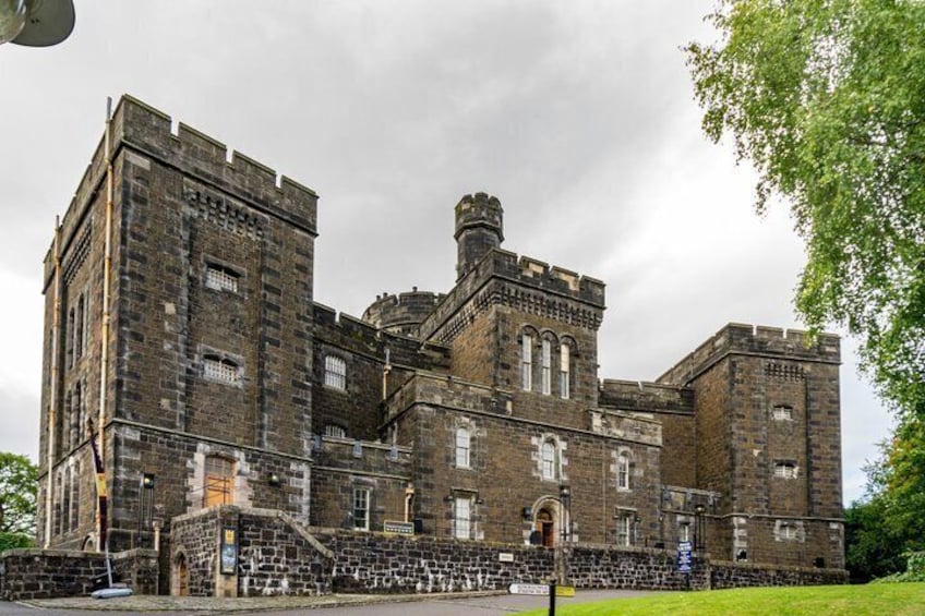 A large, historic stone building with multiple towers and arched windows. 4