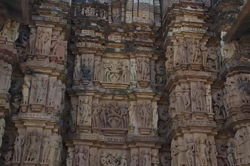 A detailed stone carving with multiple figures and scenes, likely part of a historical or religious monument. 3