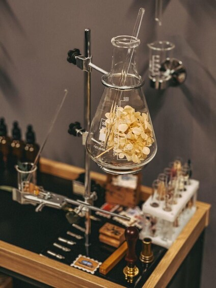 A laboratory setup with a beaker containing a liquid and a thermometer. 4
