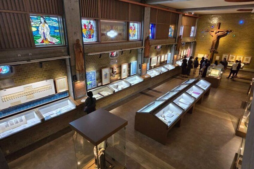 An interior with display cases and artwork on walls. 3