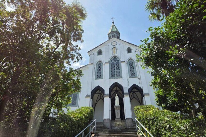 A white church with a green roof, arched windows, and a bell tower. 2