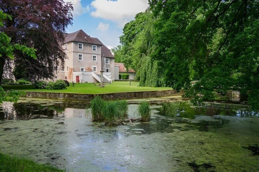 A house with a pond and greenery. 2