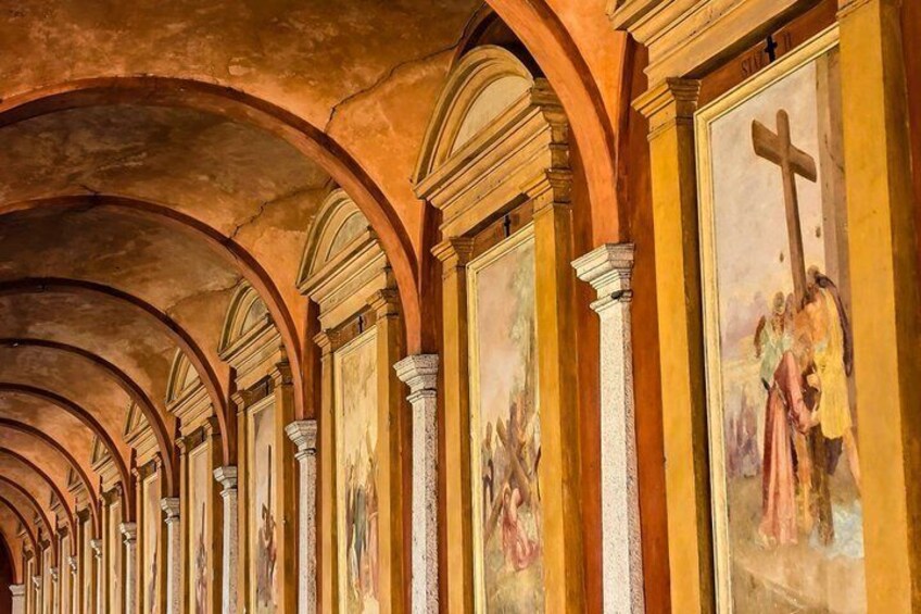 A series of arches with frescoes depicting religious scenes. 5