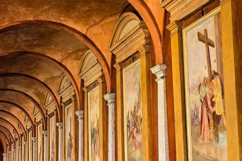A series of arches with frescoes depicting religious scenes. 5