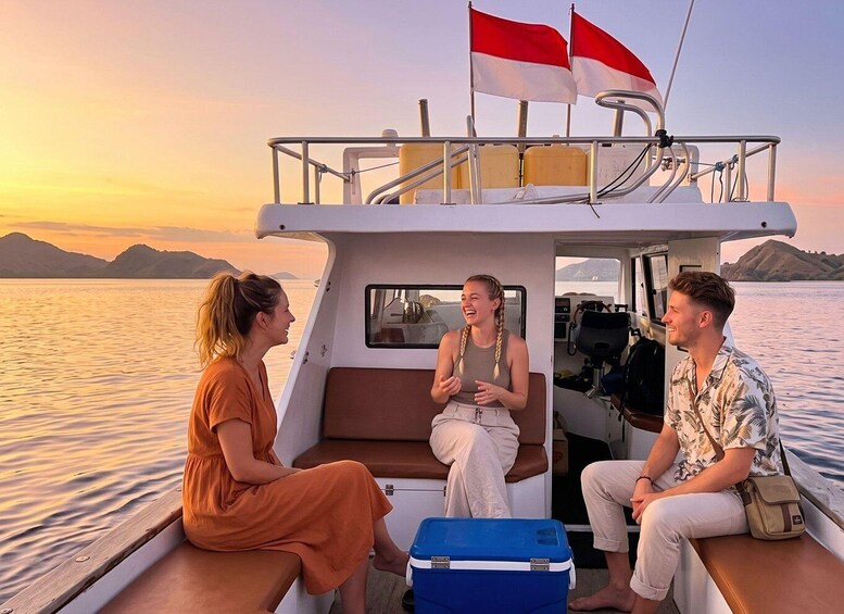 A boat with two flags, a person in an orange dress, and another in a floral shirt. 5