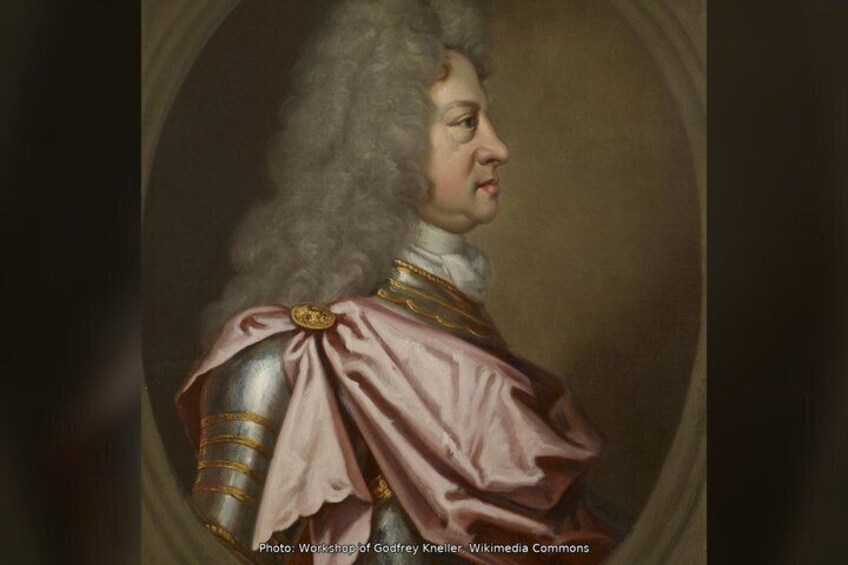 A portrait of a person in historical attire with a red sash and gold trim. 3