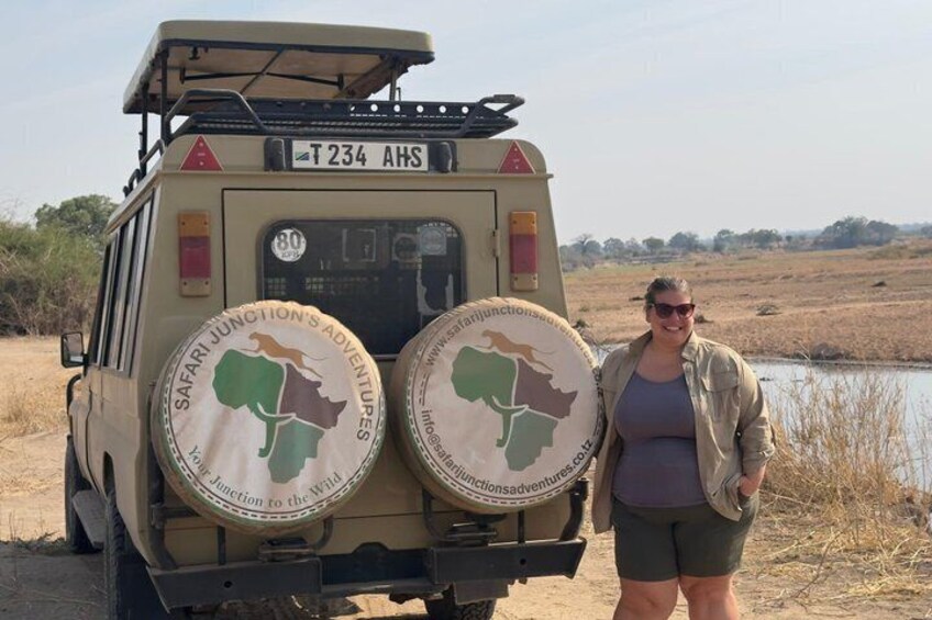 A safari vehicle with two spare wheels and a map of Africa on the back. 2