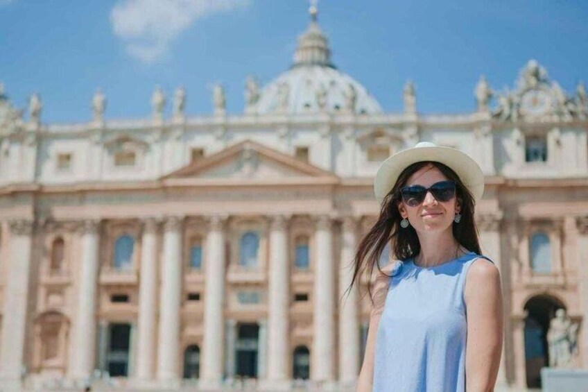 A person standing in front of a large, classical building with columns and a dome. 1
