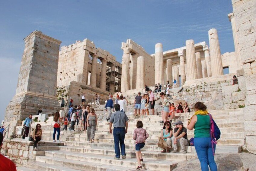 Ancient ruins with columns and steps, tourists walking and exploring. 3