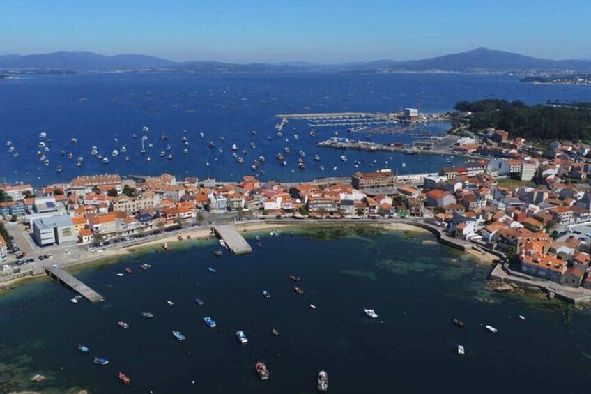 A coastal town with a marina, boats, and buildings. 1