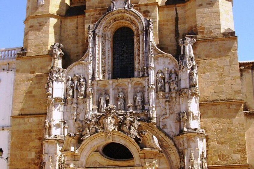 A historic building with ornate stone carvings and a large arched entrance. 4