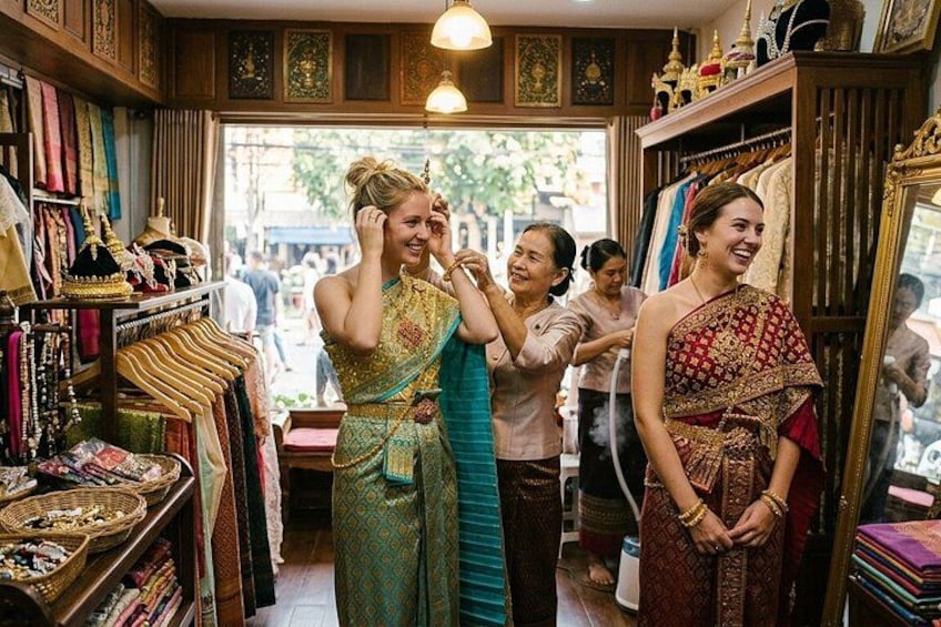 A traditional clothing store with racks of garments and decorative items. 2