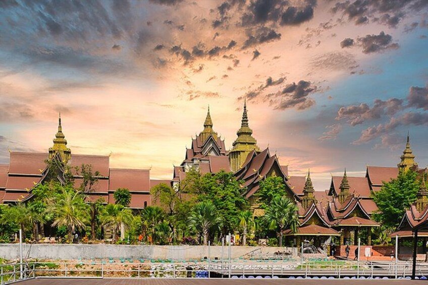 A traditional Thai temple complex with multiple structures, including ornate spires and a large central building. 1